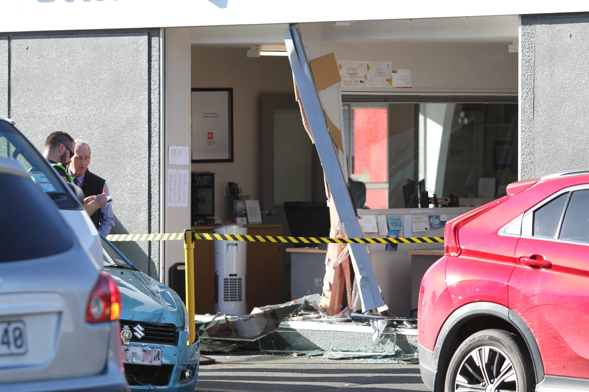 Car crashes through car dealership