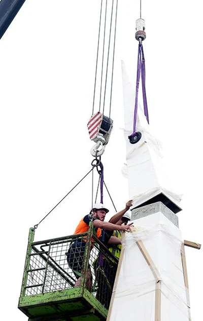 Spire hoisted into place